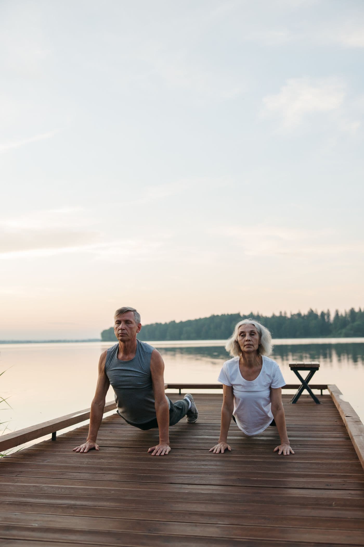 An older couple by a calm lake